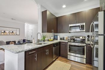 a modern kitchen with stainless steel appliances and granite counter tops